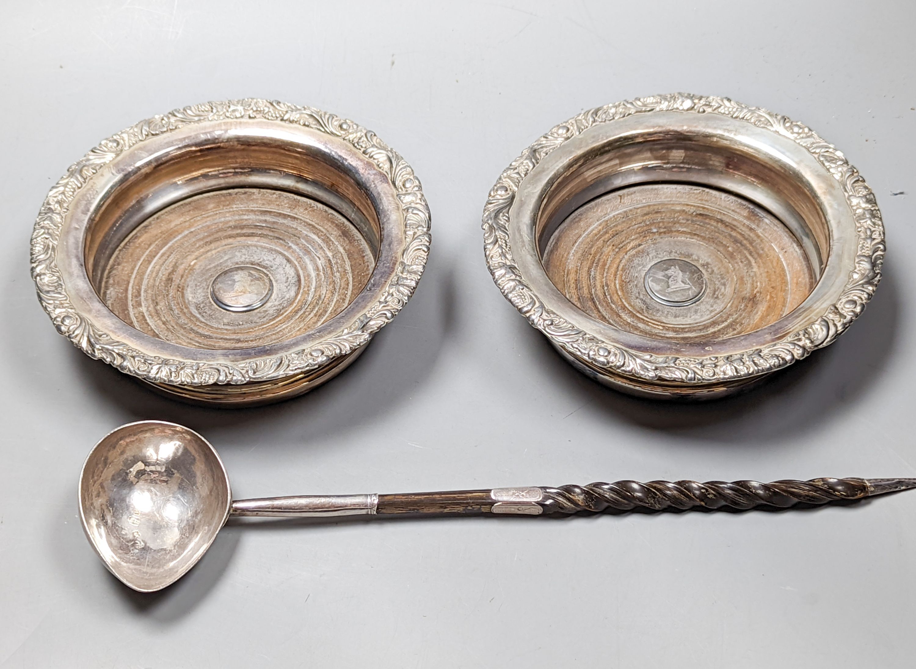 A George II silver toddy ladle, with spiral twist baleen handle, London, 1740 (a.f.) and a pair of later silver plated wine coasters, diameter 16.8cm.